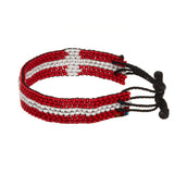 A beaded ArtiKen bracelet, handmade in Kenya, in Denmark flag colors, red, white.