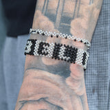 Black Silver Stretchy Handmade Bracelet from Kenya that says BELIEVE in block text