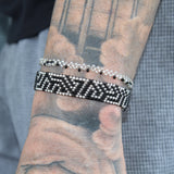 thin silver stretchy bracelet that reads "believe" in black morse code. handmade in Kenya