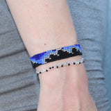 ombre blue adjustable beaded bracelet depicting black clouds with silver linings. handmade in Kenya