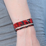 red, silver, and black adjustable bracelet depicting a storm fading into sunshine. handmade in Kenya