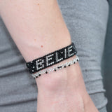 black and silver believe bracelet with a moon and saturn and stars in the background handmade in kenya