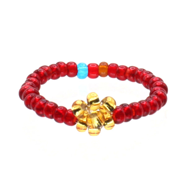 A handmade in Kenya, ArtiKen ring displays a golden flower upon a red ring. 