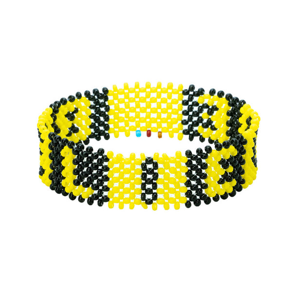 A handmade beaded bracelet from Kenya that displays the text Believe in black and yellow beads.