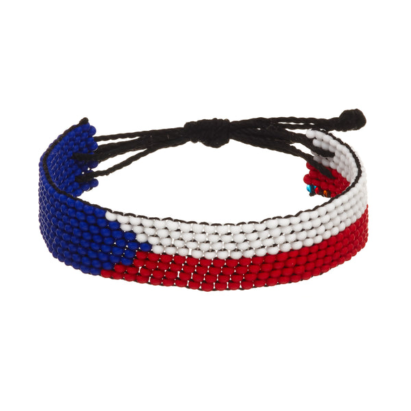 A beaded ArtiKen bracelet, handmade in Kenya, in Czech Republic flag colors, blue, white, red.
