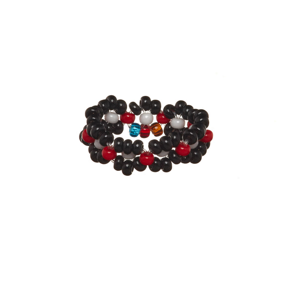 A beaded ArtiKen ring, handmade in Kenya, in black, red, and white beads.
