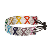 A beaded ArtiKen bracelet, handmade in Kenya, in white, with the cancer ribbon in different colors.