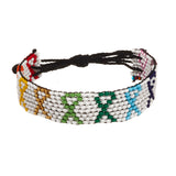 A beaded ArtiKen bracelet, handmade in Kenya, in white, with the cancer ribbon in different colors.