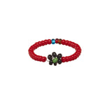 A beaded ArtiKen ring, handmade in Kenya, in red, black, and green beads. 