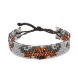 A handmade in Kenya, ArtiKen bracelet with a white background displays Buffalo's in brown beads. 