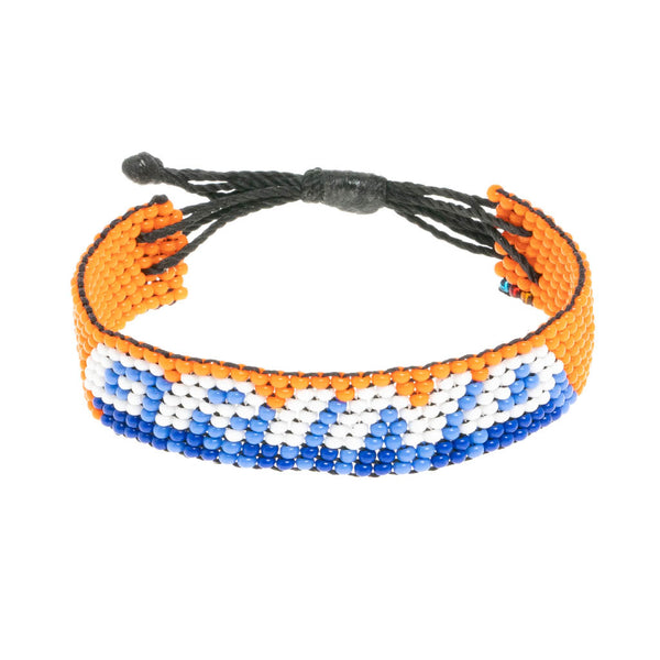 A handmade beaded bracelet from ArtiKen created in Kenya displaying the text GRIND in orange and white.