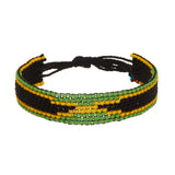 A beaded ArtiKen bracelet, handmade in Kenya, in Jamaica flag colors, green, yellow, and black.