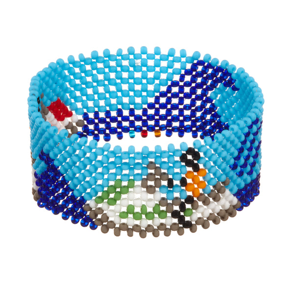 A beaded ArtiKen bracelet, handmade in Kenya, showcasing a day out on the waves, a blue background with dark blue waves and two people on red and green jet skis. 