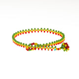 A handmade in Kenya ArtiKen bracelet displays the colors of green, yellow and red in our OG style.