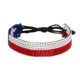 A beaded ArtiKen bracelet, handmade in Kenya, in Texas flag colors, blue, white, red.