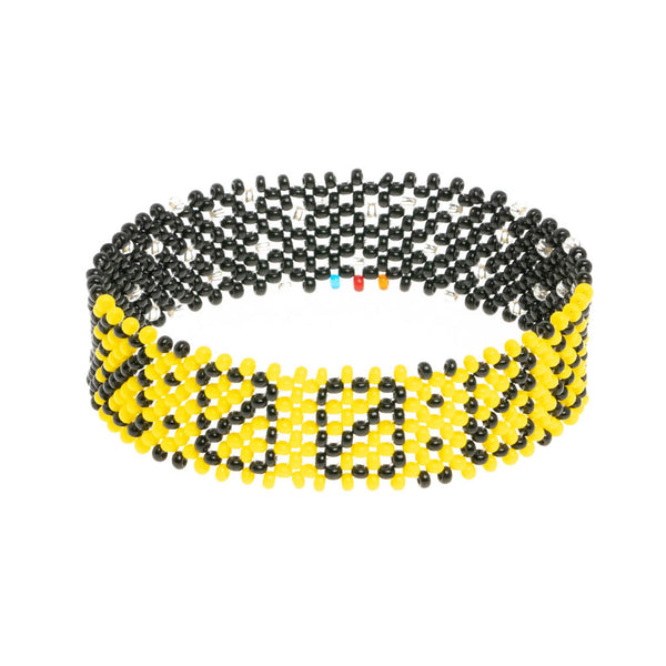 A handmade in Kenya bracelet by ArtiKen displays all zeros in black.A handmade in Kenya bracelet by ArtiKen displays all zeros in black.