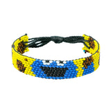 A handmade beaded bracelet from Kenya displays a tough monster who likes cookies.