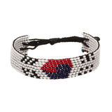 A beaded ArtiKen bracelet, handmade in Kenya, showcasing a South Korea flag, in a white background with black, red, and blue beads. 